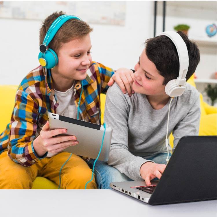 Two children play together on the computer