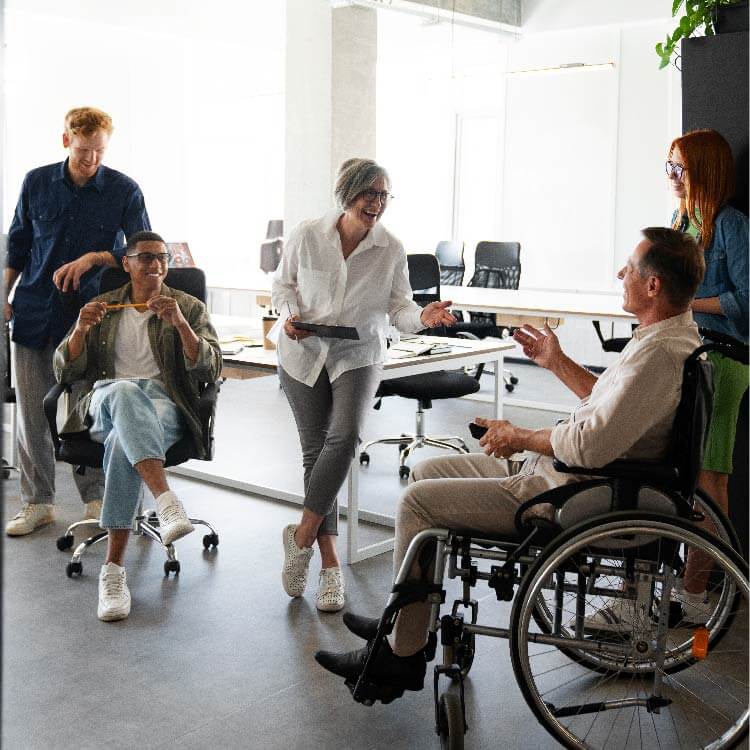 Team with wheelchair participant at work