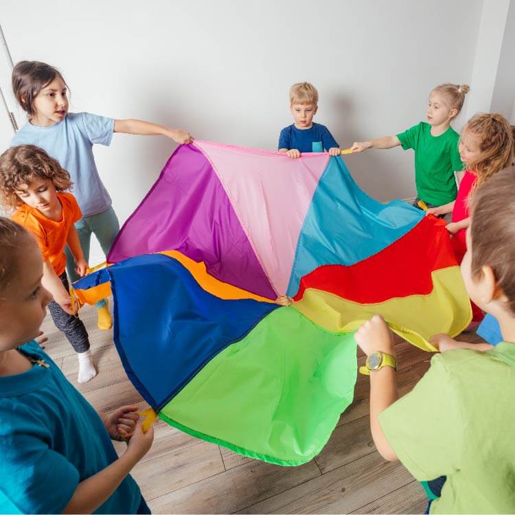 Children hold a colorful cloth together